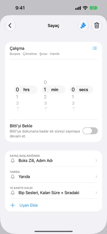Çalışma adlı 1 dakikalık adım için sayaç adımı düzenleyicisi; adın altında Burpee, Çömelme, Şınav ve Hamle tekrar adları ve yanında bir liste simgesi. Bitti’yi Bekle kapalı. Uyarılar: Sayaç Başladığında, Yarıda ve 10 saniye kaldı; ardından Uyarı Ekle.